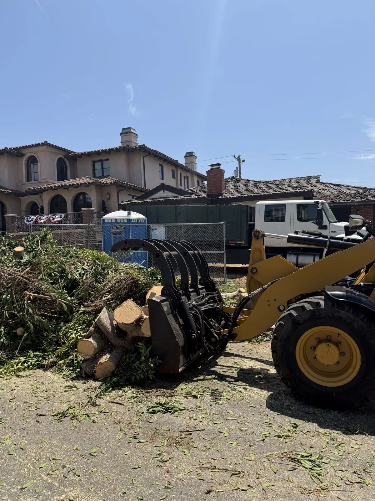 Our grapple loader clearing brush and green waste at a large property