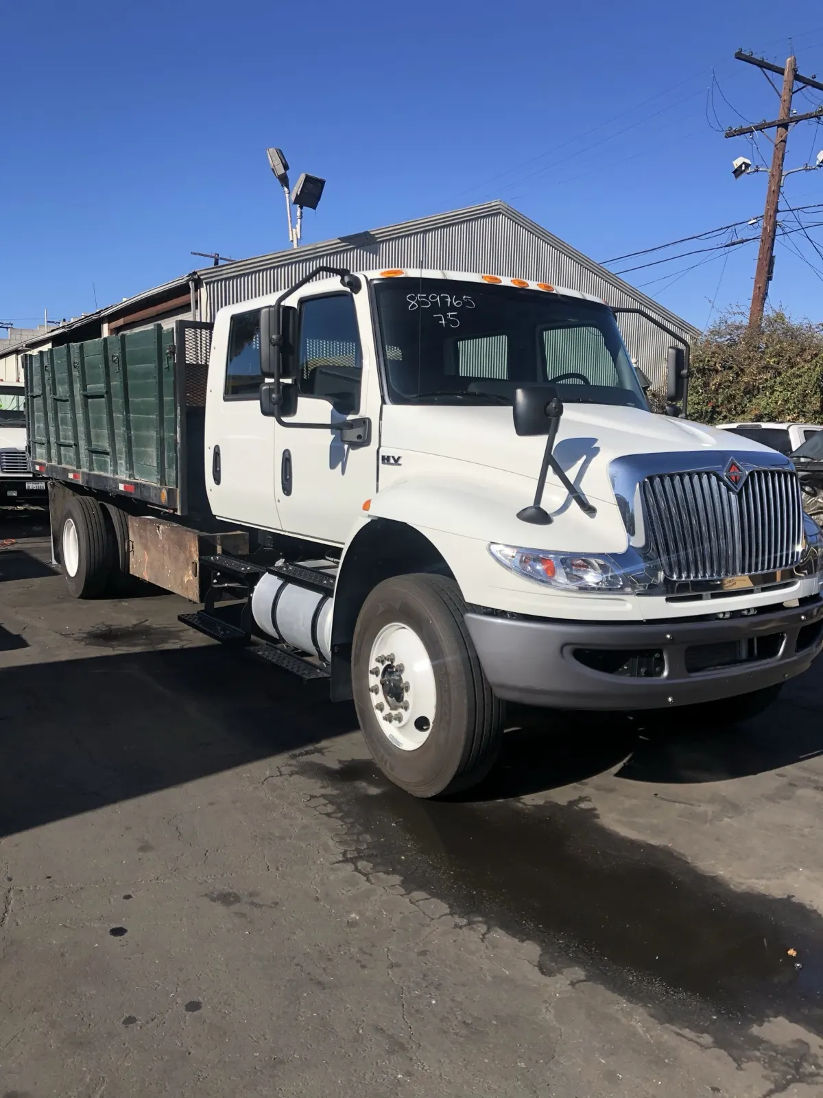 One of our crew-cab dump trucks with a stake bed at the truck yard