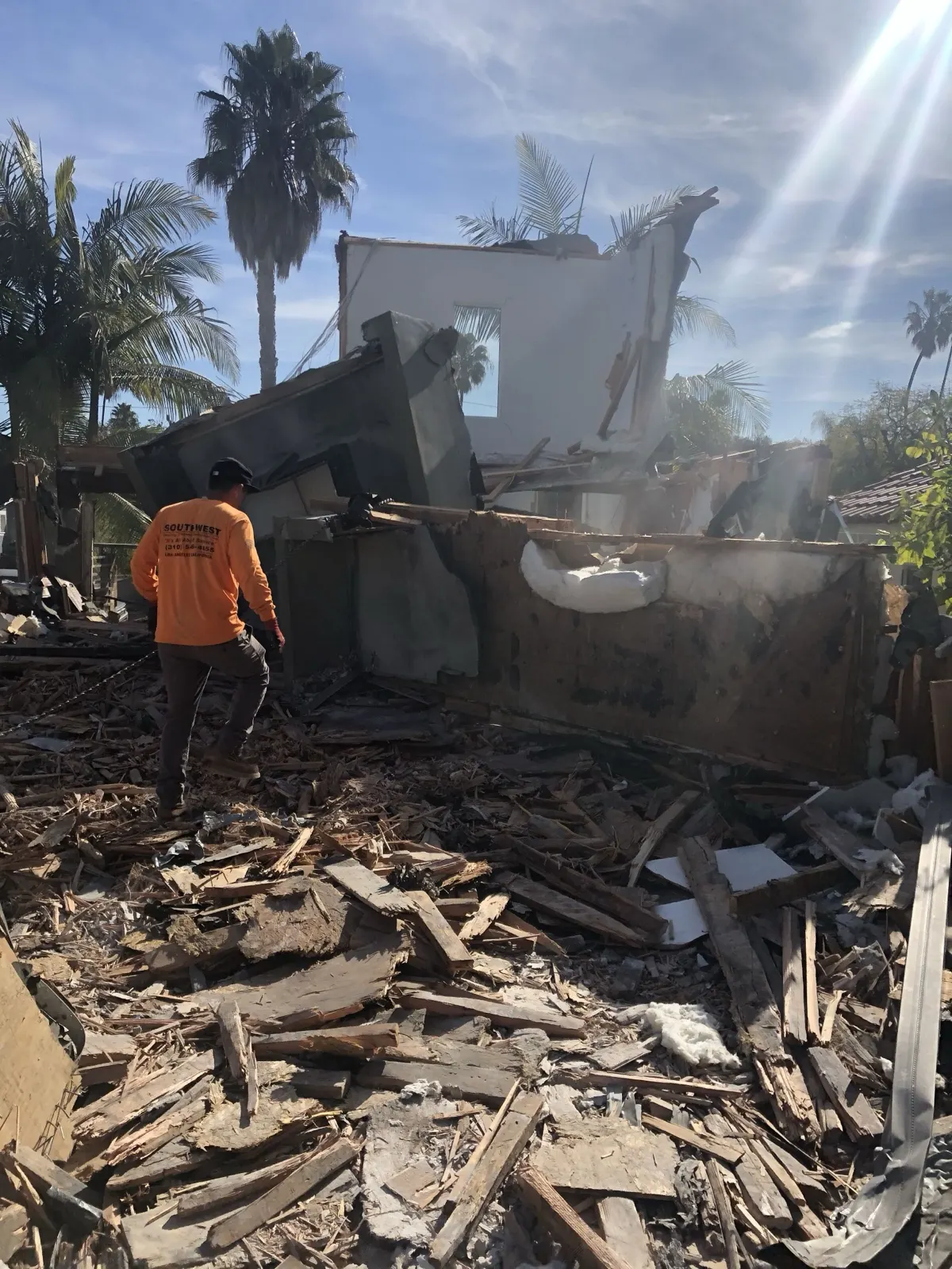 Our crew working through the wood debris of a torn-down structure