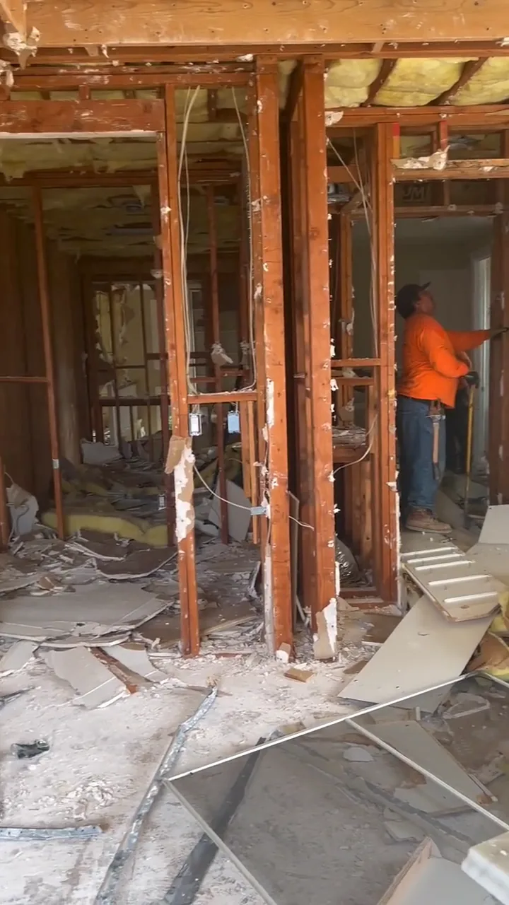 Interior demolition in progress with the walls opened down to the framing